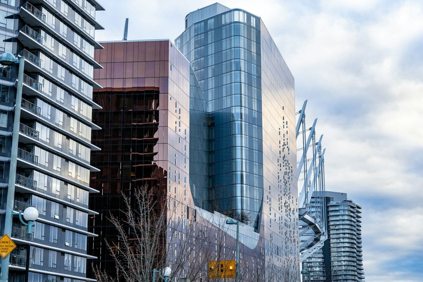 Glass condo towers against a blue sky