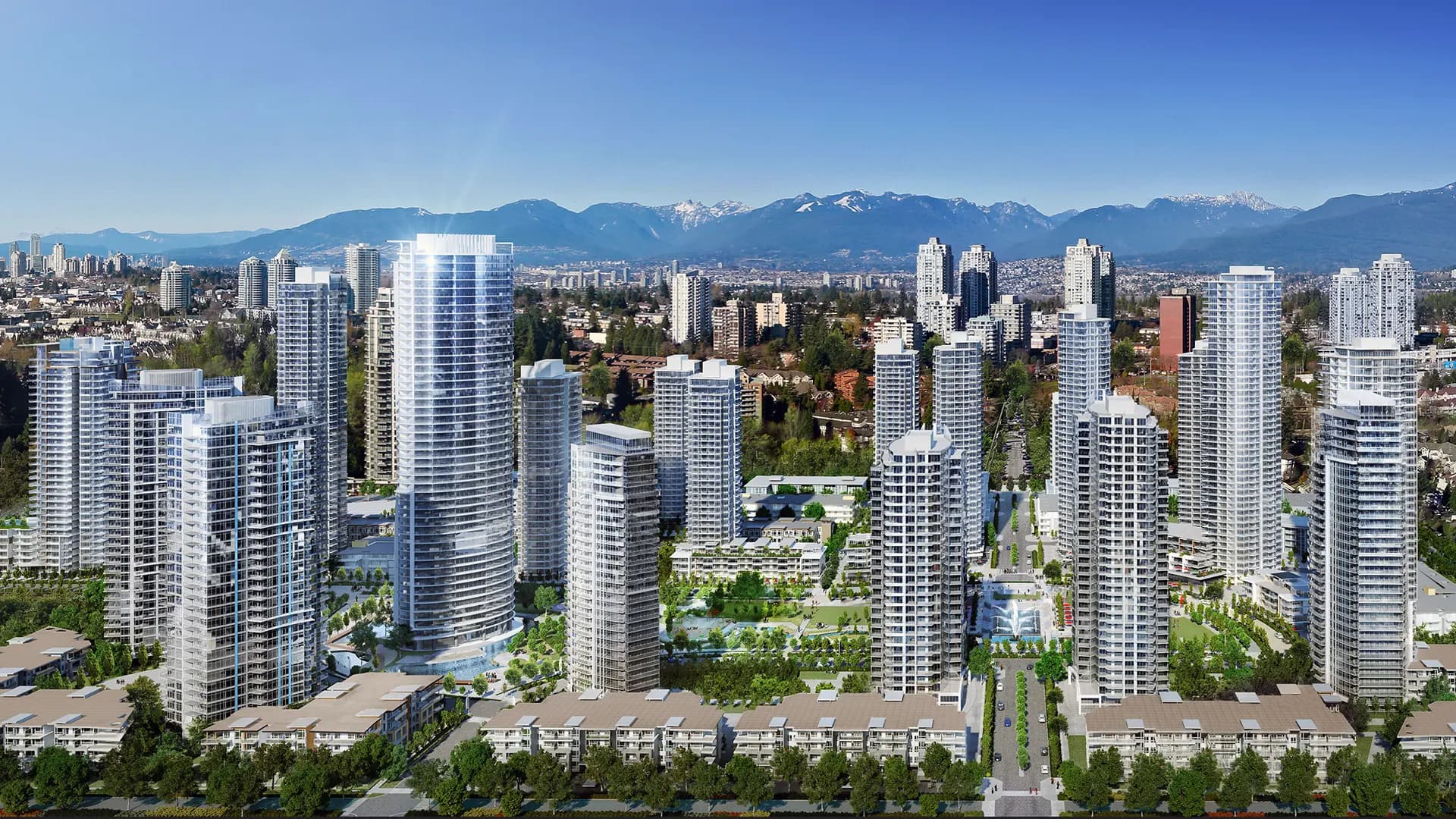 Southgate City – A daytime aerial view of a large cluster of glass high-rise towers with a central landscaped park and pond, framed by snow-capped mountains in the background.