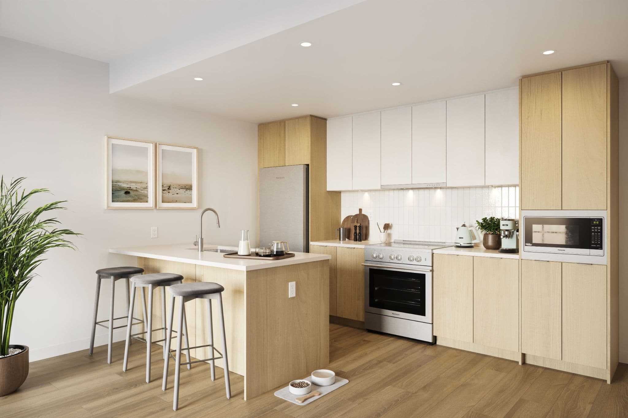 Market Commons – A bright, contemporary kitchen featuring light wood cabinetry paired with upper white cabinets, white countertops, and stainless steel appliances. A central island with an undermount sink offers breakfast bar seating with three grey stools on light hardwood flooring.