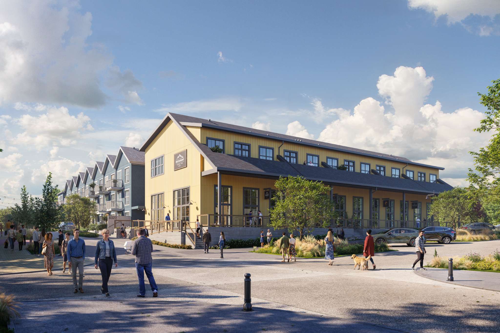 Market Commons – A ground-level view of a vibrant pedestrian street featuring a two-story yellow barn-style commercial building with a restaurant alongside multi-family residential buildings with pitched roofs. People and dogs stroll along paved walkways and landscaped plazas under a bright, sunny sky with scattered clouds.