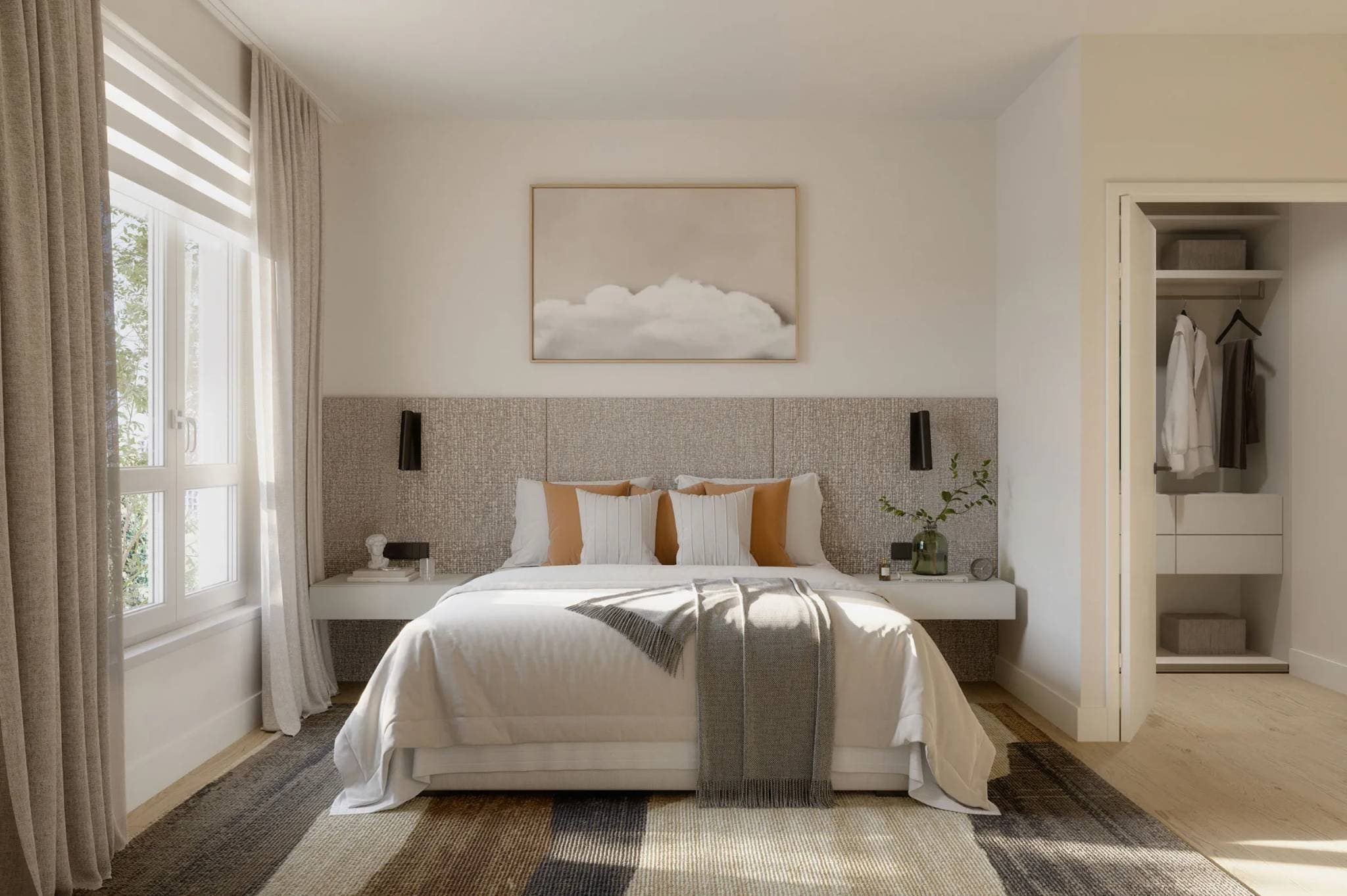 Level – A bright, modern bedroom featuring a neatly made bed with an extended textured headboard wall, floating nightstands, and soft neutral linens with warm terracotta accent pillows. Sunlight streams in from a large window on the left, highlighting the wood flooring, framed artwork above the bed, and an open walk-in closet in the background.