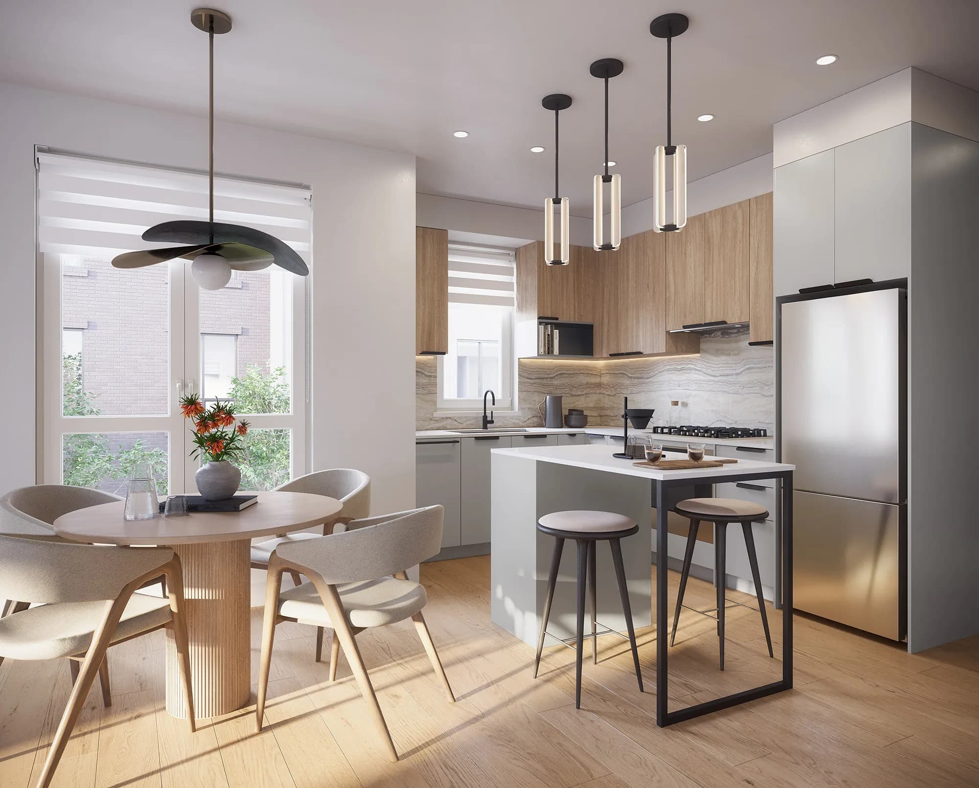 Level – A bright, open-concept kitchen and dining area featuring light wood floors, two-tone cabinetry in pale gray and natural wood, and stainless steel appliances. A round wooden dining table sits beside a large window, accompanied by a small island with counter seating under sleek modern pendant lights.