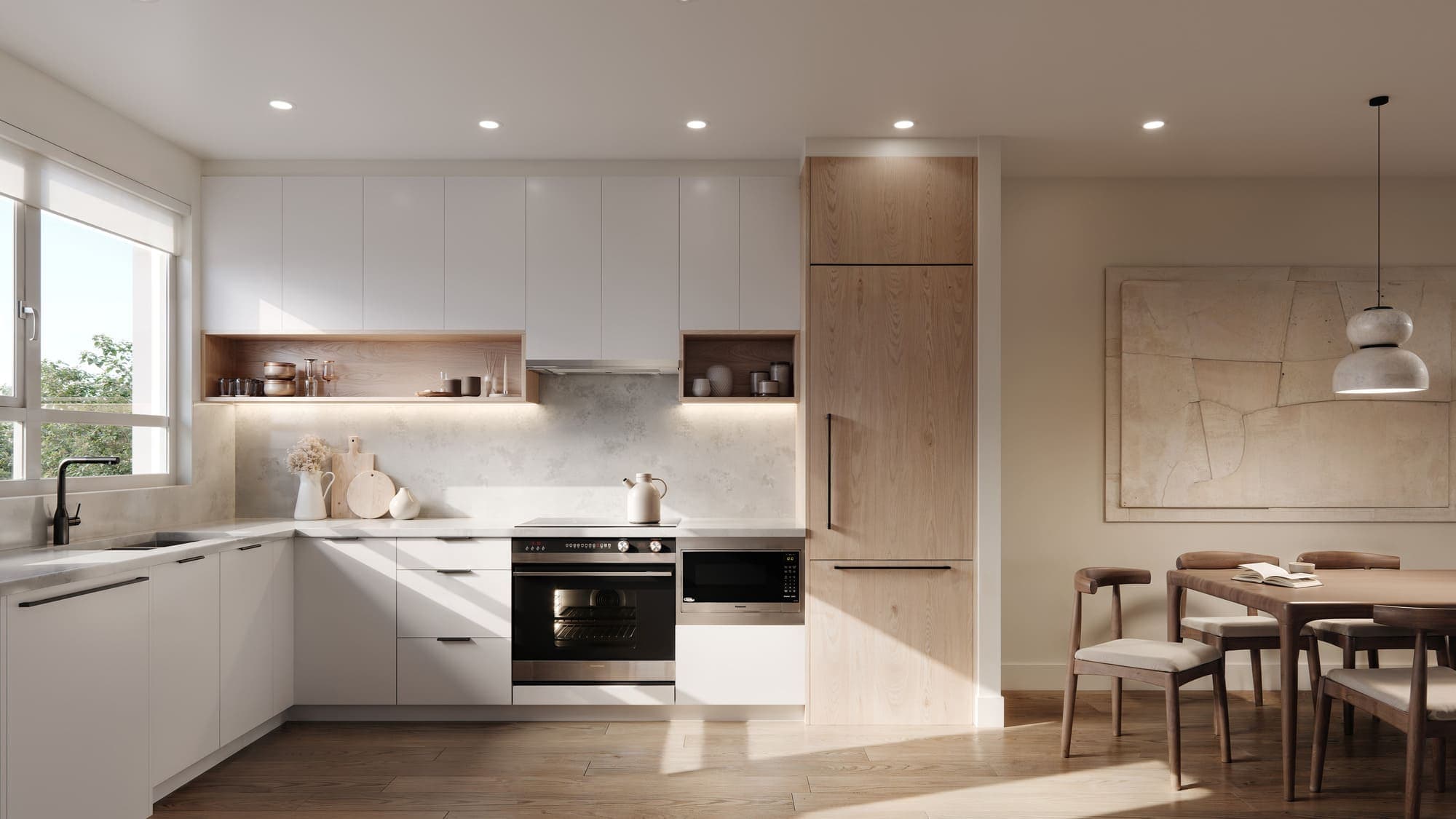 Oaklyn – A white kitchen with wood open shelving, built-in oven and microwave, a light wood tall cabinet, and a dining table visible beyond.