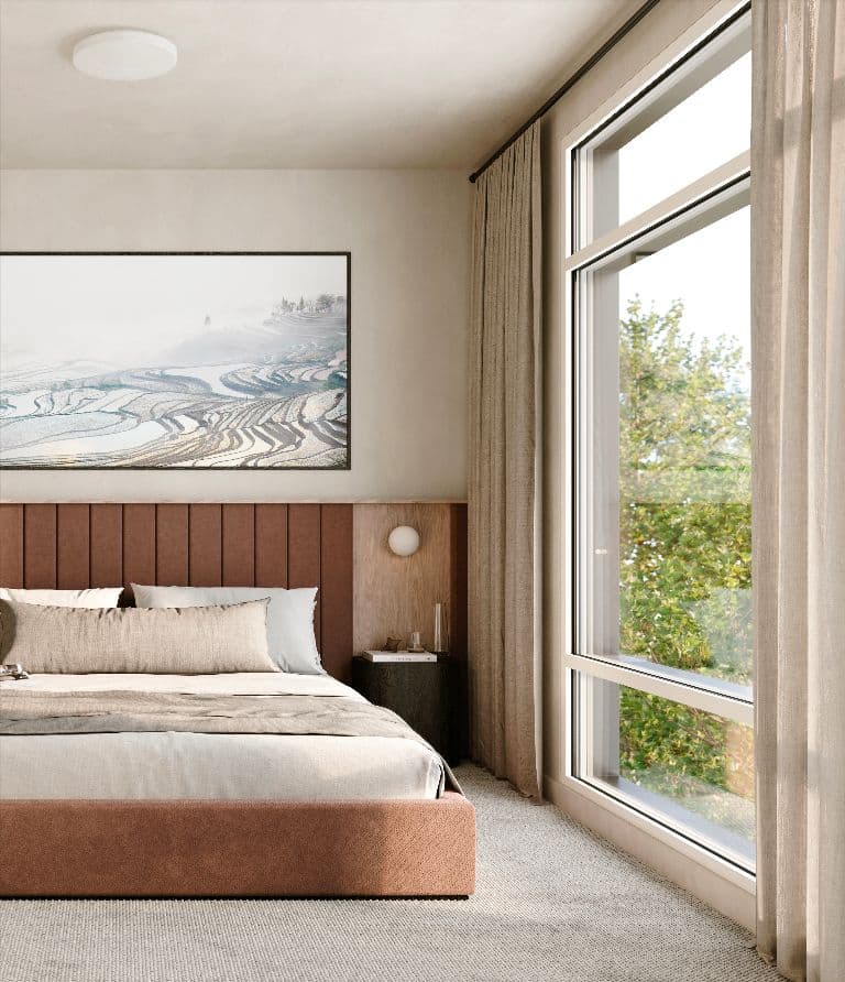 Rowen W47th – Bedroom with a rust-colored upholstered bed and headboard, a framed landscape painting, and a floor-to-ceiling window overlooking trees.