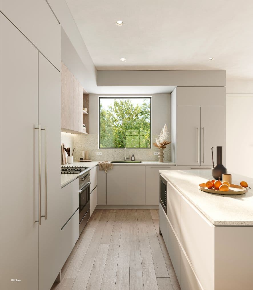 Rowen W47th – U-shaped kitchen with light wood upper cabinets, terrazzo-look countertop and backsplash, an island with a fruit bowl, and a window view of trees.