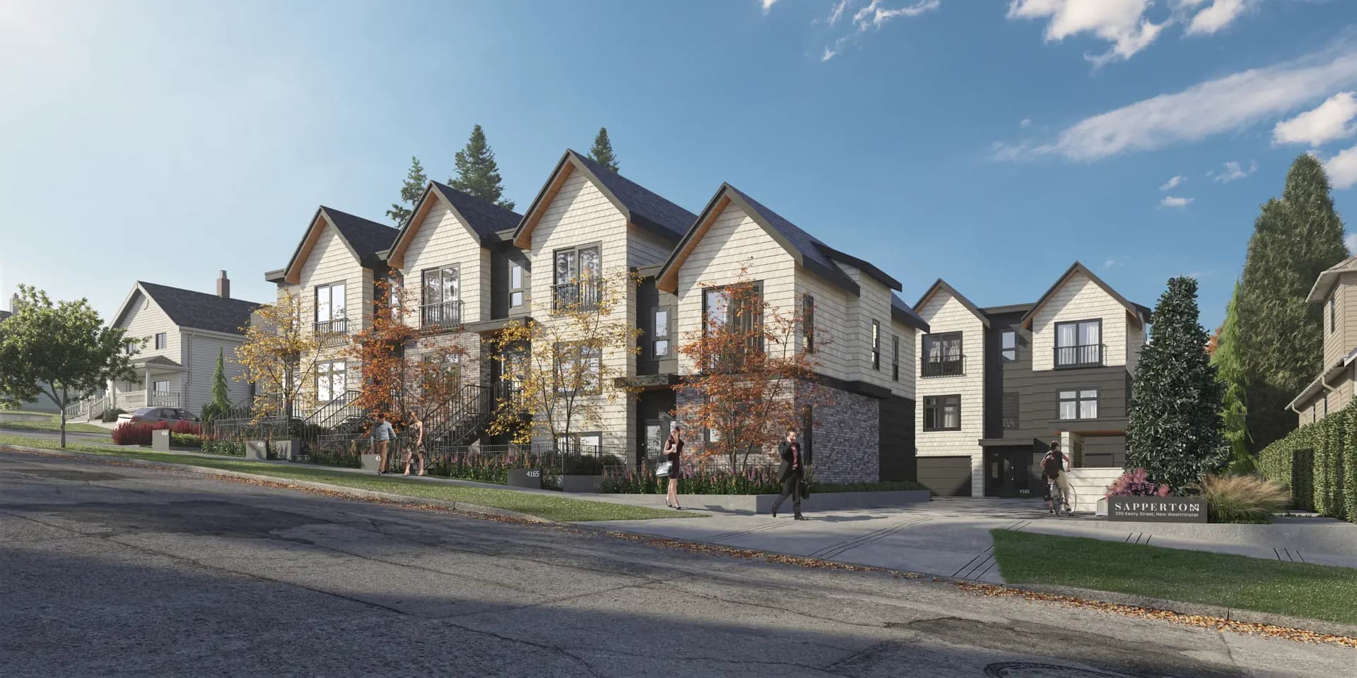 Sapperton – Street-level daytime view of a row of shingle-style townhomes with gabled roofs, named 'Sapperton' on a sign, with people walking outside.