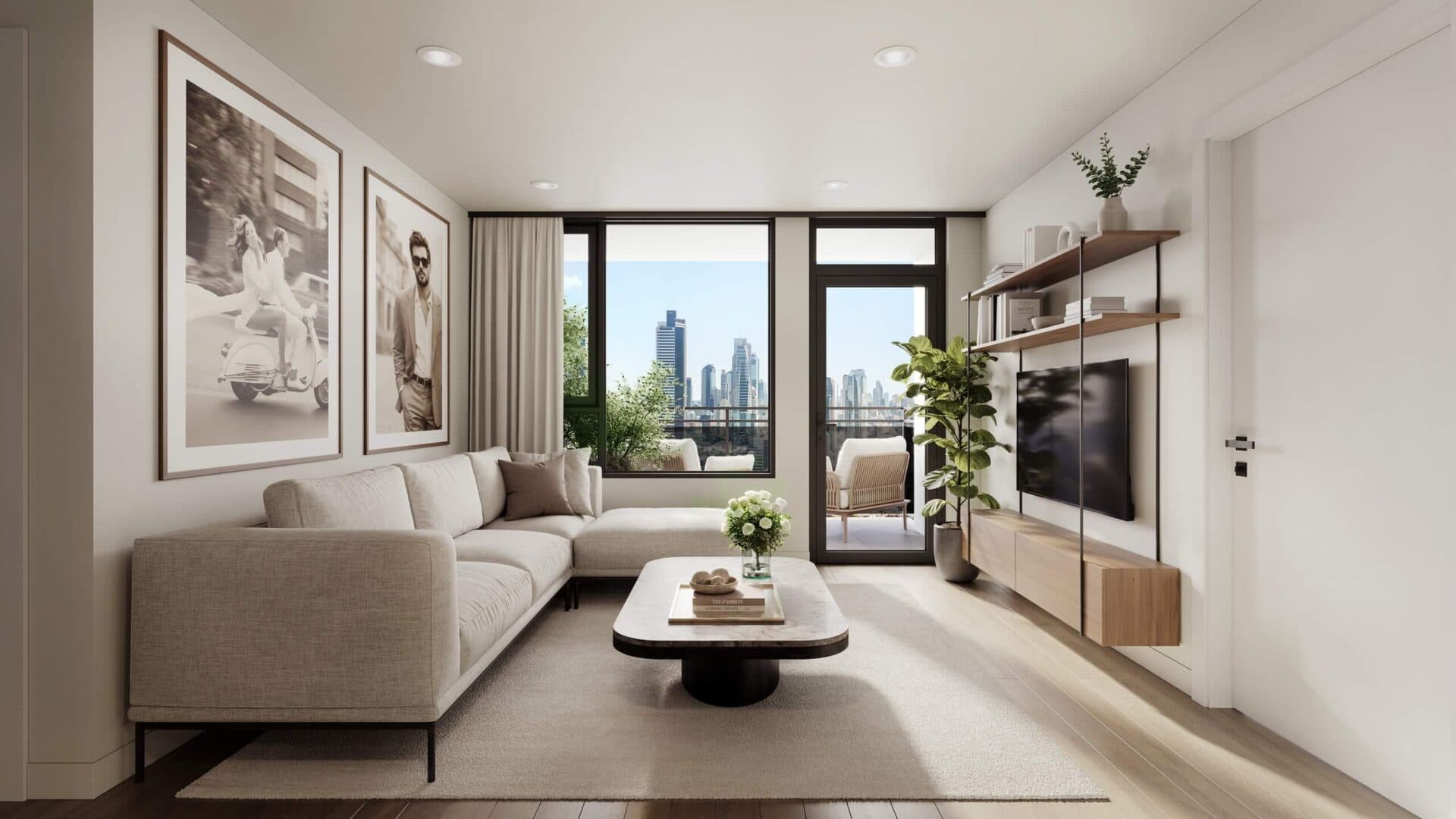 Centrale – A modern living room features a light beige sectional sofa, a low marble-topped coffee table, and a wall-mounted TV with floating wood shelving. Bright daylight streams in through a glass door and window that open to a balcony with patio seating and a view of a distant city skyline.