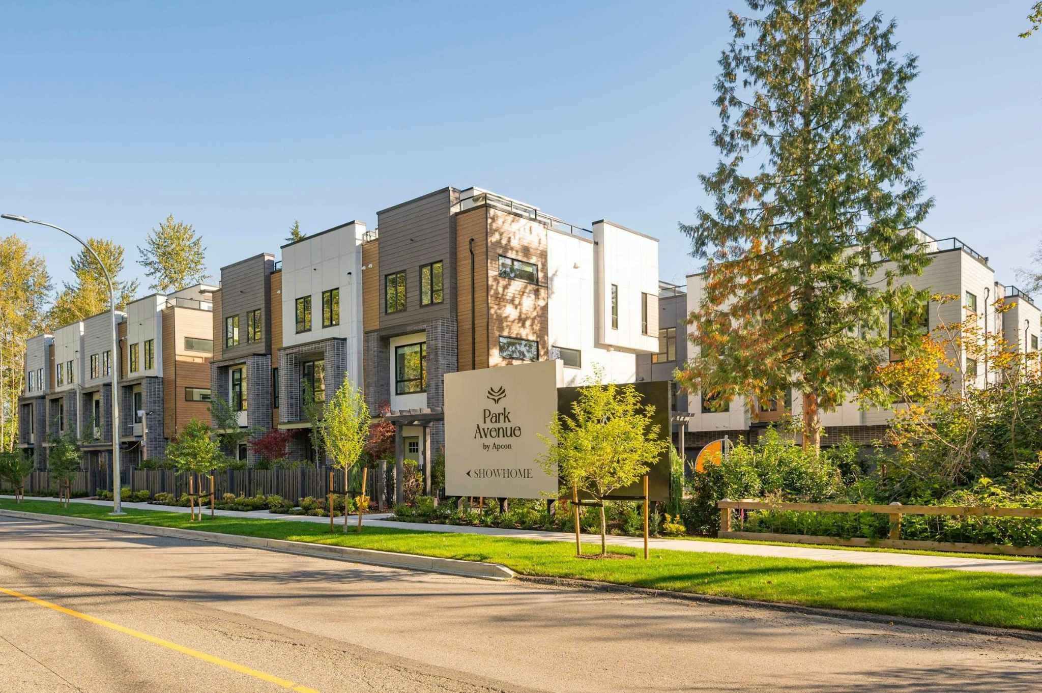 Park Avenue Townhomes – Street-level view of the Park Avenue townhome development complex with manicured landscaping, sidewalk, and project signage.