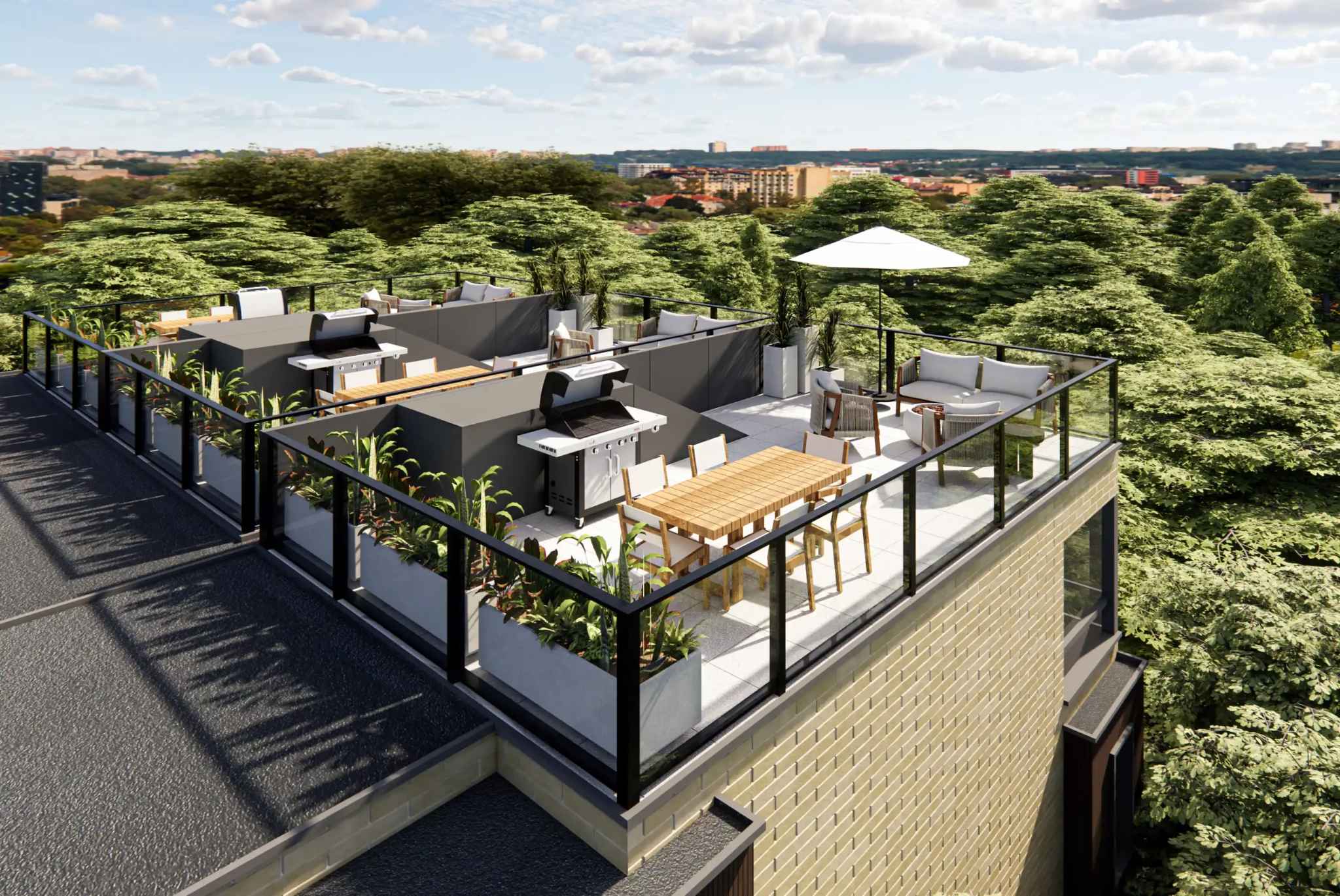 Core Townhomes – Rooftop deck with built-in BBQ stations, a wood dining table, lounge seating under an umbrella, planters, and a tree-lined city view.