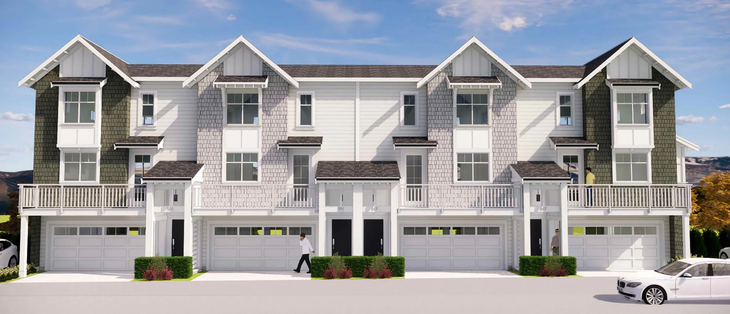 Ocean Park – A straight-on architectural rendering displays a row of modern three-story townhomes with white lap siding, grey shingle accents, and prominent gable roofs. Each unit features ground-level garage doors, front entrance porticos, and second-story balconies with white railings under a clear blue sky.