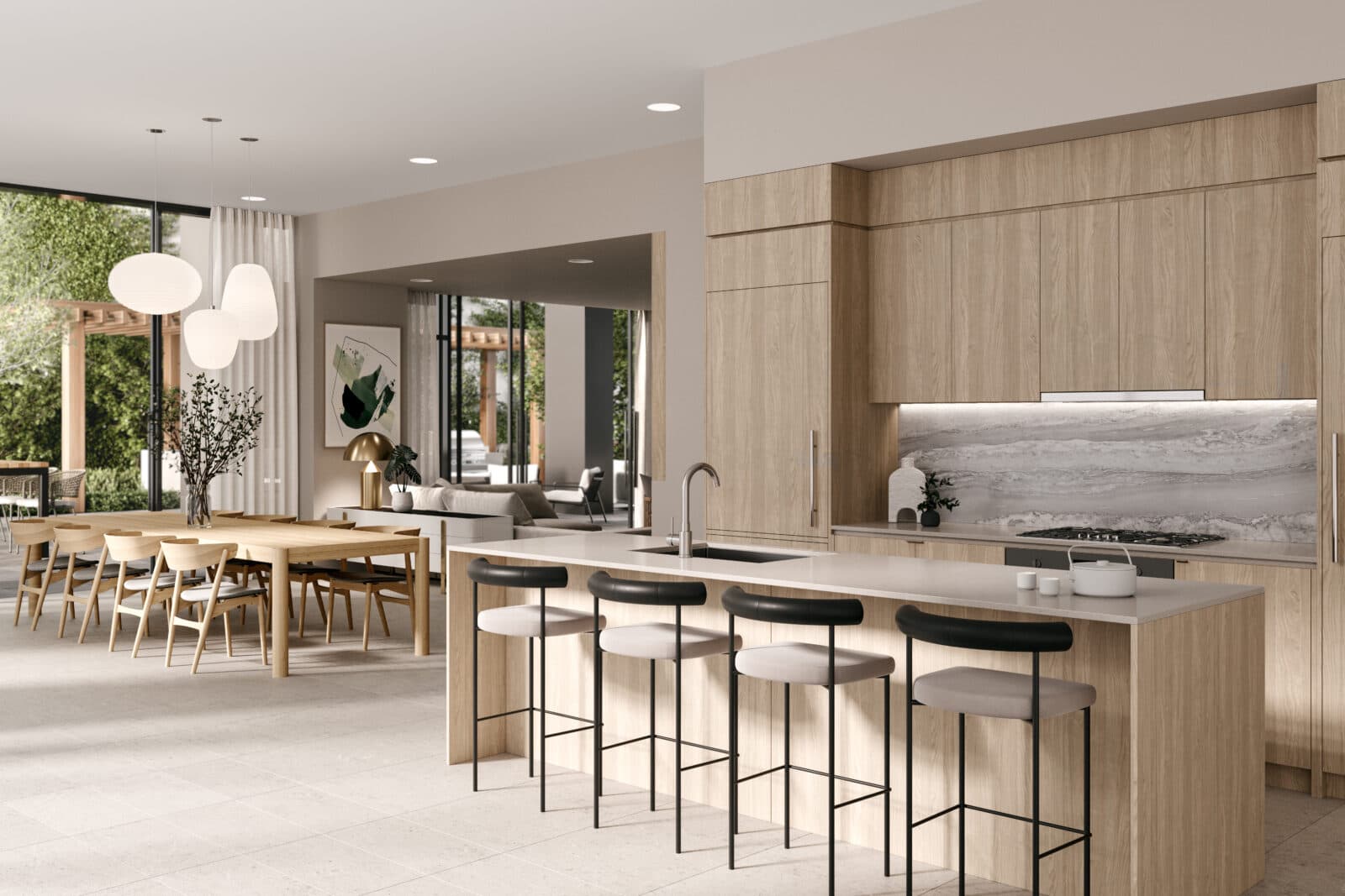 Jinju – An open-concept modern kitchen and dining area featuring light wood cabinetry, a large waterfall island with four barstools, and a matching long wooden dining table. Large floor-to-ceiling glass sliding doors lead out to a lush green patio and garden bathed in natural daylight.