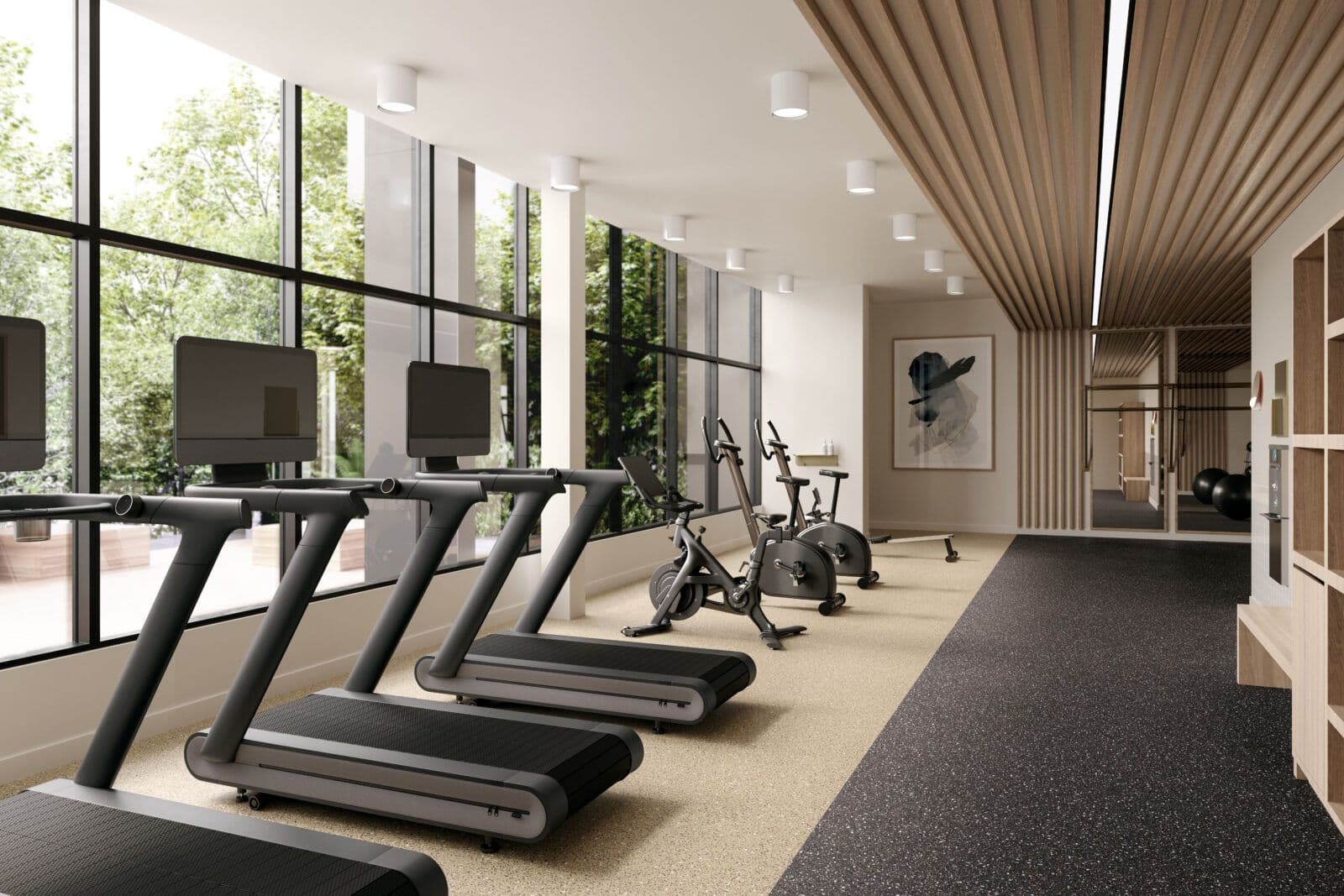 Jinju – A bright, modern residential gym lined with sleek black treadmills and stationary bikes facing floor-to-ceiling windows with views of outdoor greenery. Warm wood-slat ceiling details, minimalist white walls, and a divided light-and-dark speckled floor create an airy, upscale workout environment.