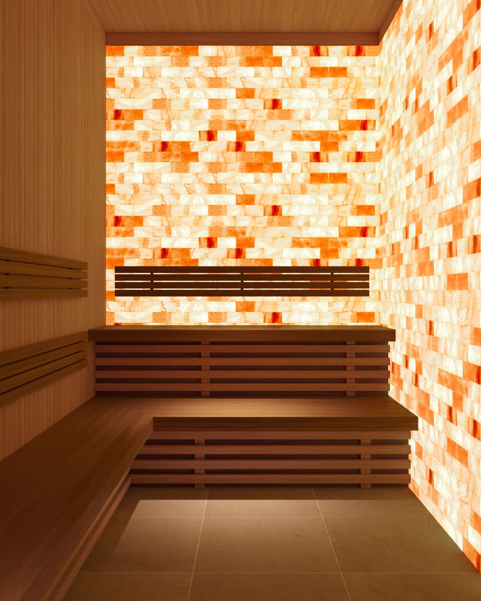 Jinju – A modern Himalayan salt sauna room featuring illuminated orange salt brick walls, light wood-paneled accents, and tiered slatted wooden benches over a tiled floor. The ambient backlighting creates a warm, relaxing, and therapeutic spa atmosphere.