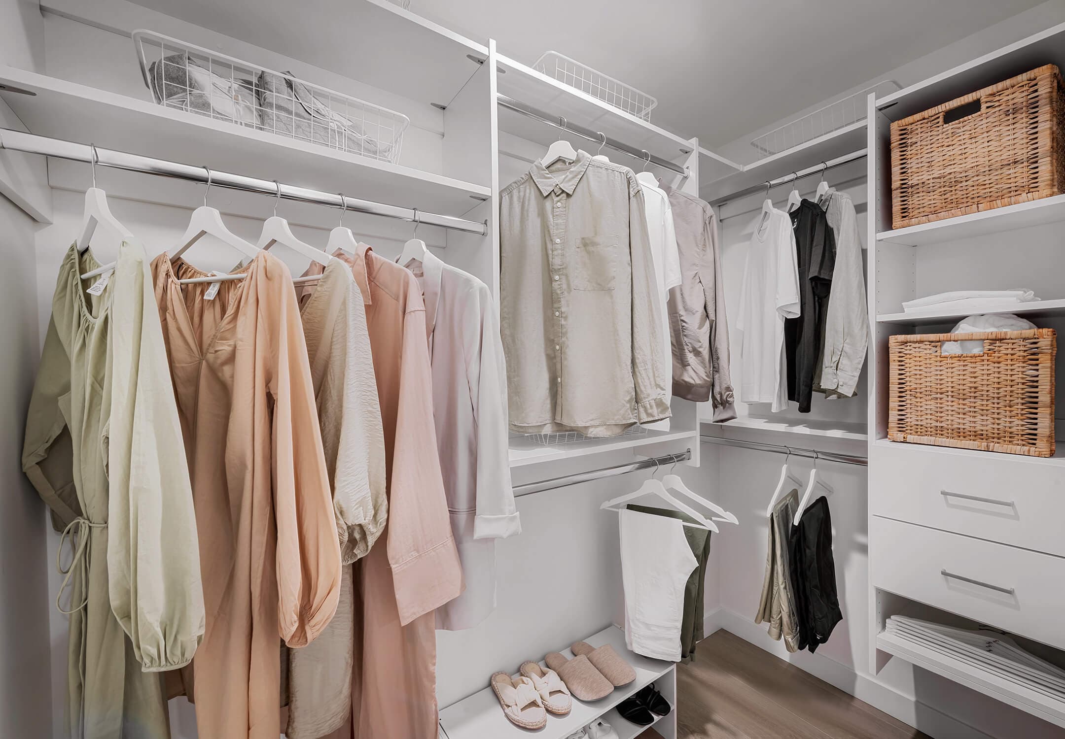 Century City Holland Park - Park Tower 1 – Walk-in closet with white shelving, hanging rods full of clothing, wire baskets, and woven storage bins.