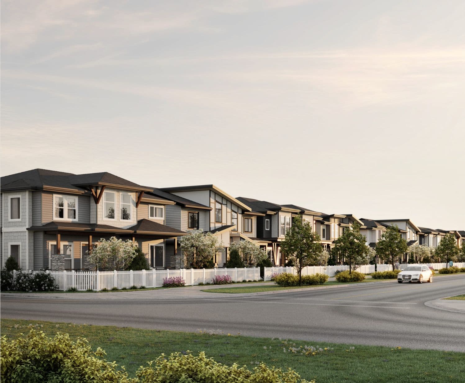 Latimer Landing – Rendering of a row of two-story single-family and townhome-style houses with varied gray, tan, and dark siding along a residential street at dusk.