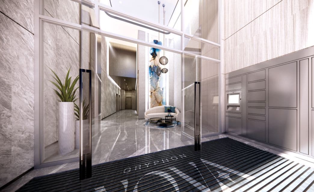 Gryphon Nova Condos – A rendering of a building lobby entrance with glass doors, marble walls, a decorative art piece, and mail lockers, with 'Gryphon Nova' etched into the floor mat.