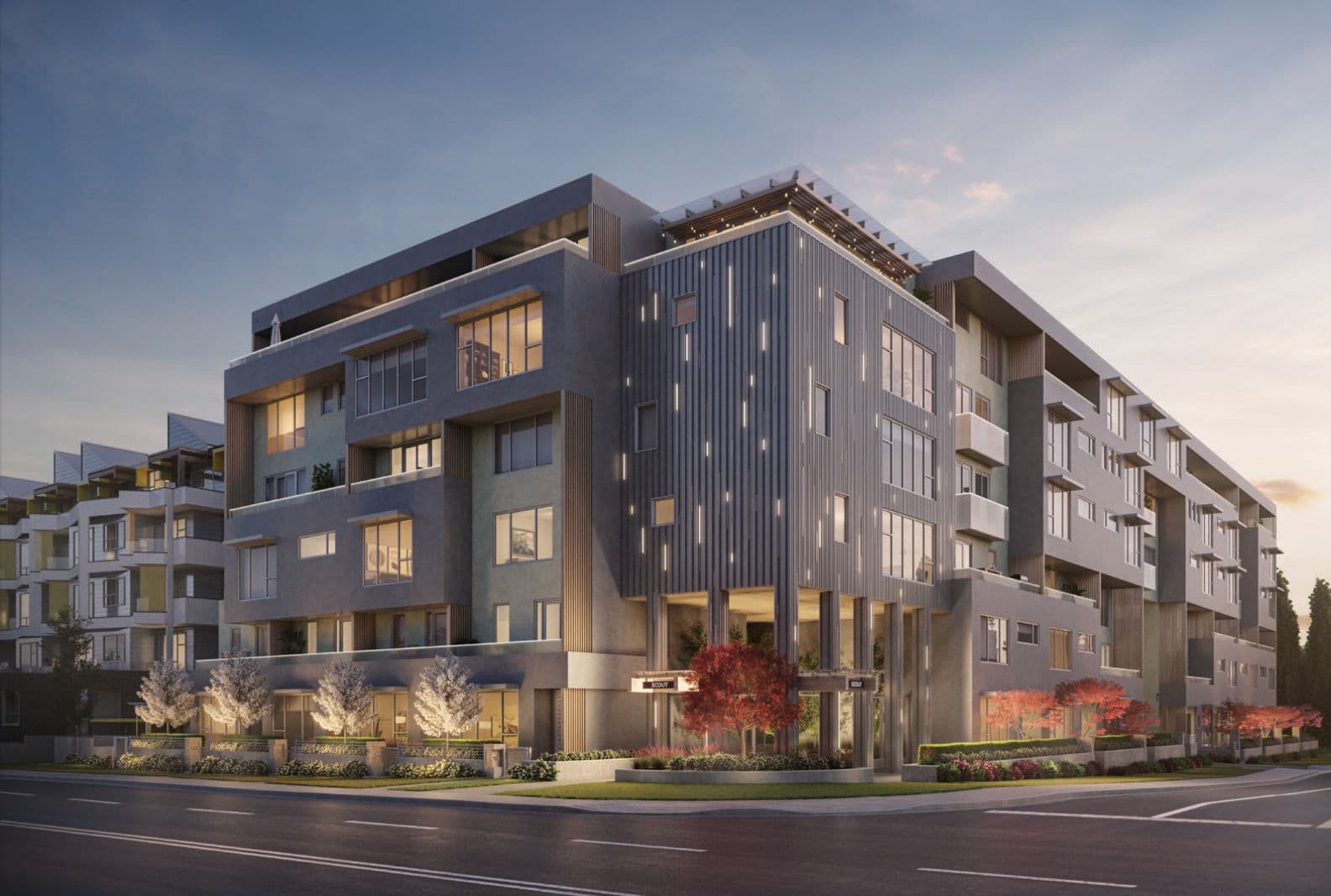 Scout – Twilight rendering of a modern grey mid-rise condo building on a street corner, with balconies, a vertical fin facade, and red maple trees at the entrance.