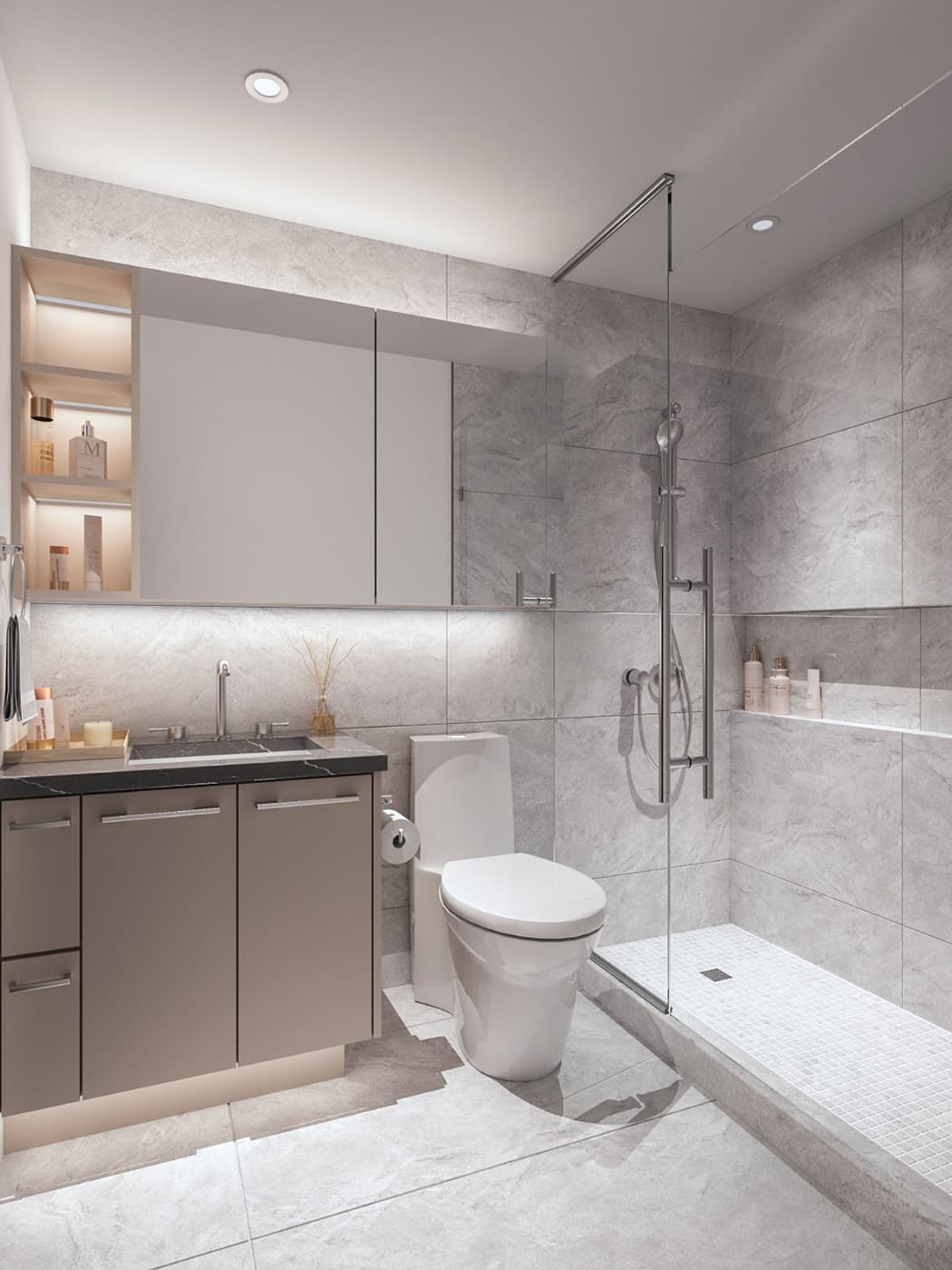 Oasis at Concord Brentwood – A modern bathroom interior featuring large gray marble-look wall tiles, a glass-enclosed walk-in shower with mosaic floor tile, and a floating taupe vanity with a dark stone countertop. Soft warm LED under-cabinet and shelf lighting enhances the sleek, upscale ambiance.