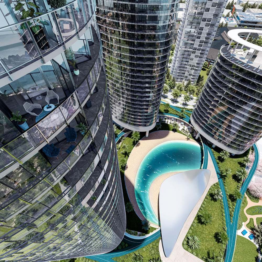 Oasis at Concord Brentwood – A high-angle bird's-eye rendering captures modern, curved high-rise glass residential towers surrounding a central courtyard. The central amenity space features a lagoon-style pool with a sandy edge, lush green lawns, palm trees, and walking paths under bright daylight.