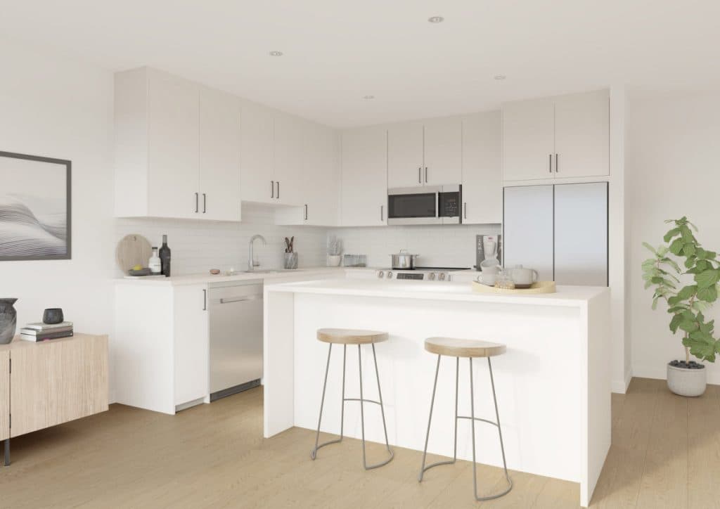 Montvue – White kitchen with an island bar seating two stools, built-in refrigerator, microwave and tile backsplash.