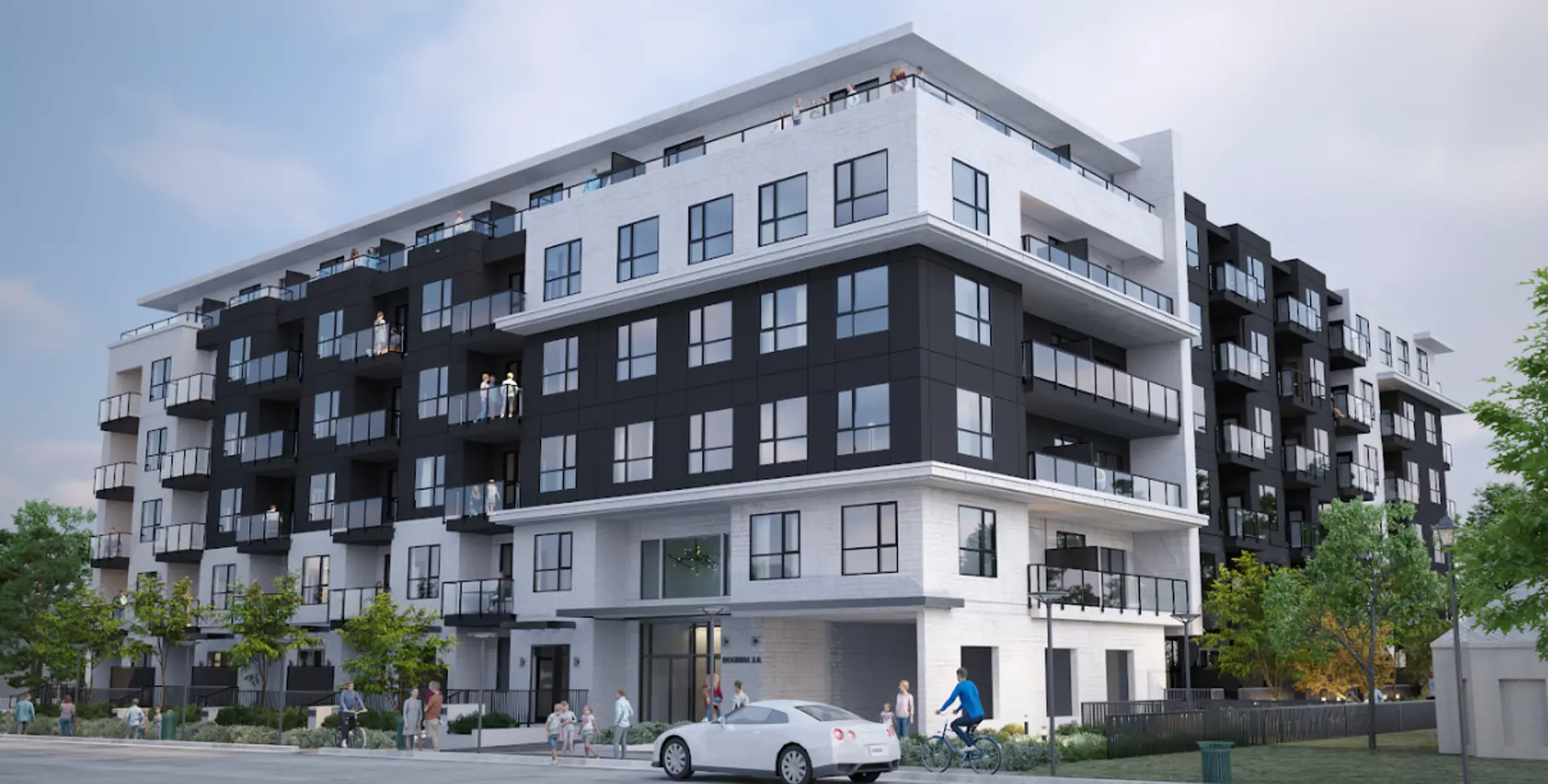 Bourna 2.0 – Corner view of a mid-rise condo building with alternating black and white panel sections, balconies, and pedestrians and cyclists on the street below.