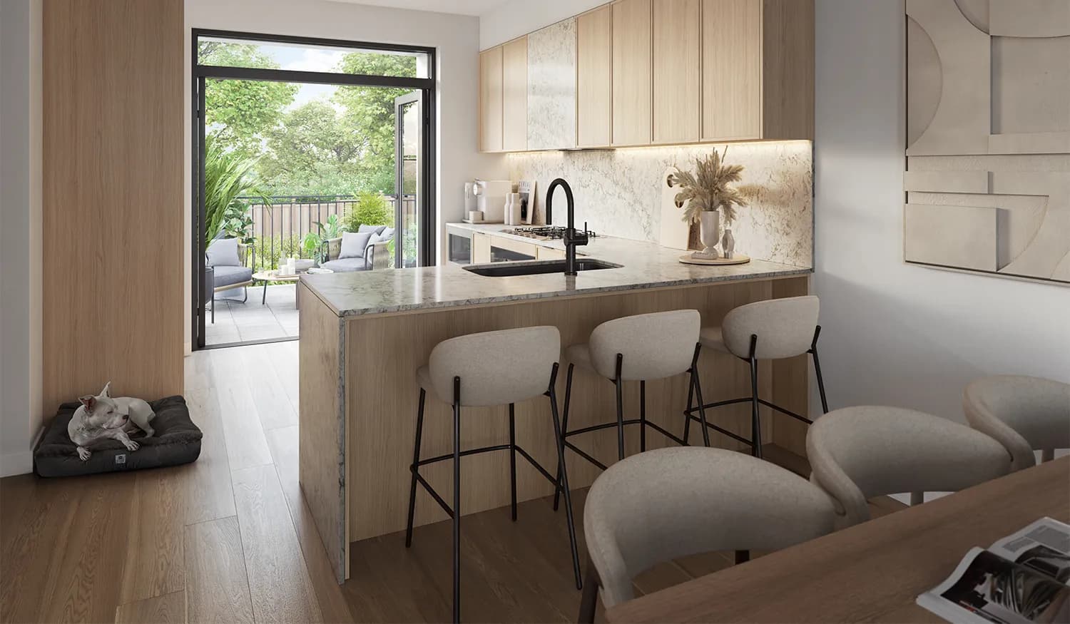 Whitford – A modern open-concept kitchen feature light wood cabinetry, white-veined stone countertops and backsplash, and a large island paired with sleek fabric bar stools. Open glass patio doors in the background reveal a private balcony with outdoor seating surrounded by lush green trees on a bright, sunny day.