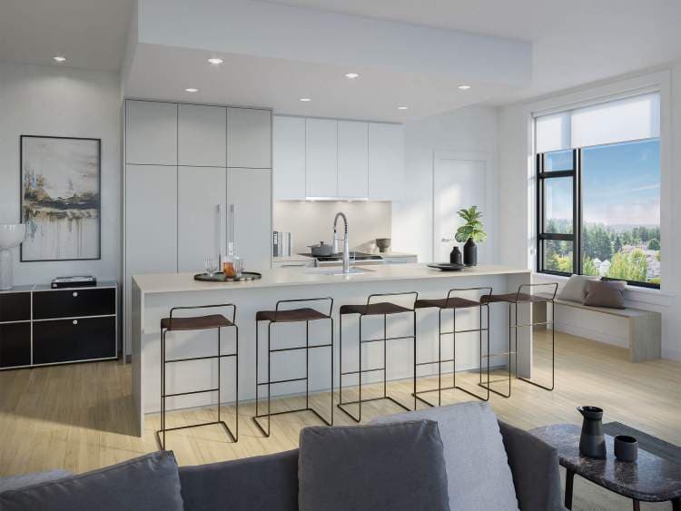 One Shaughnessy – Modern kitchen with white cabinetry, a long island with dark barstools, and a large window bench seat overlooking treetops, opening to a grey sofa in the foreground.