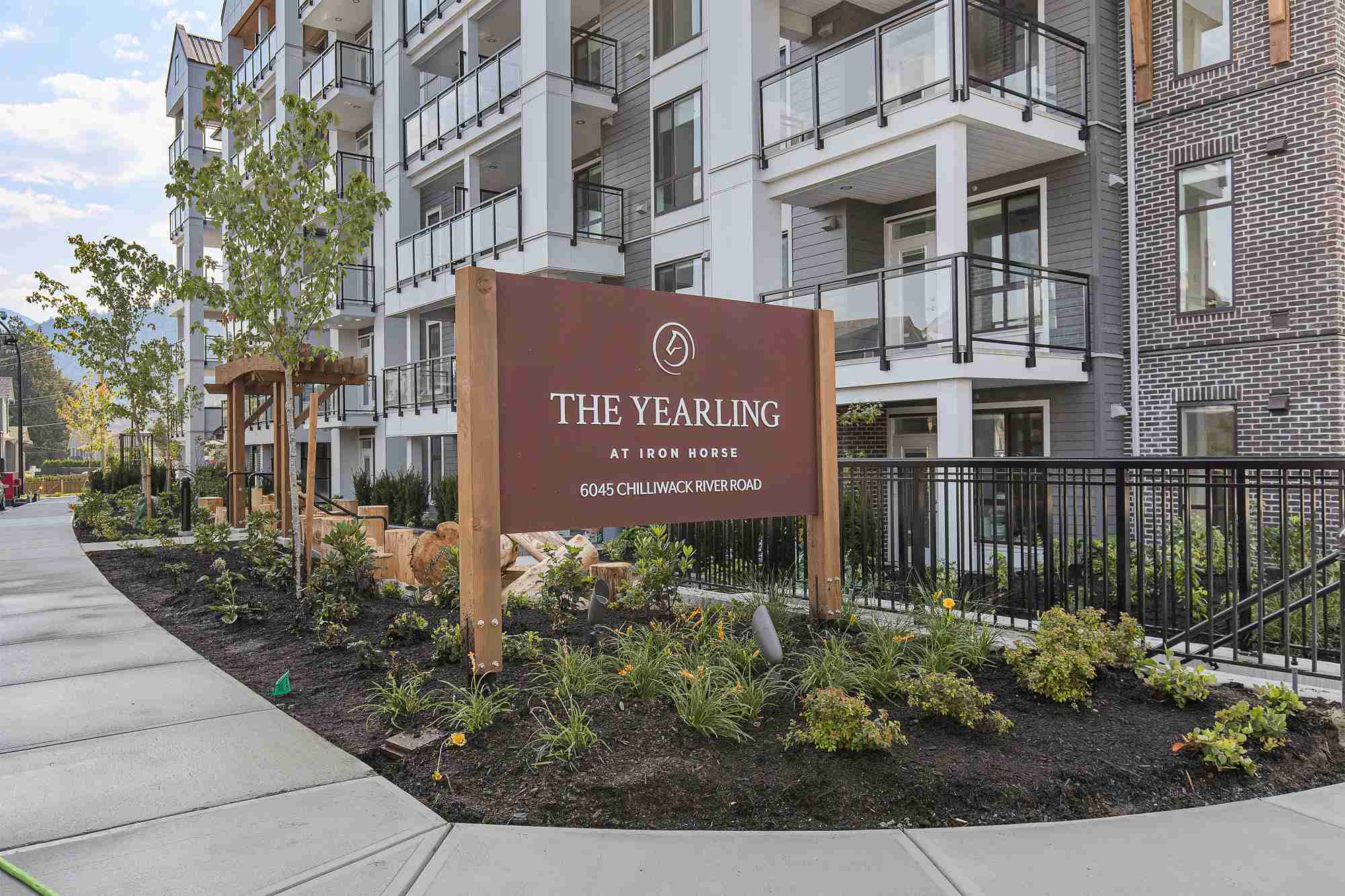 The Yearling – Entrance sign reading 'The Yearling at Iron Horse, 6045 Chilliwack River Road' in front of the building facade.