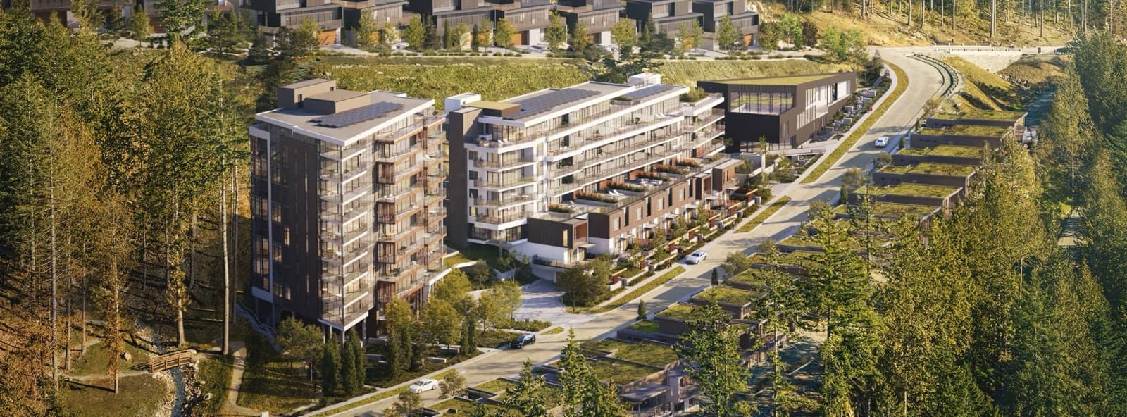 Hawksley – Overhead drone rendering of the development showing the tower, mid-rise building and rowhomes surrounded by forest, with a road and parking below.