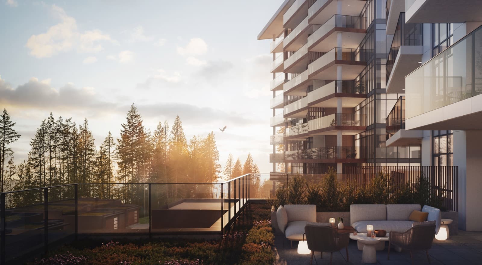 Hawksley – Rooftop terrace lounge with sofas and armchairs around a fire pit, overlooking a forested hillside at sunset.