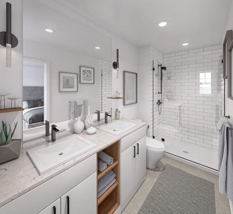 Havenridge – Bathroom with a double vanity, subway-tiled walk-in shower, toilet, and bedroom visible through the doorway.