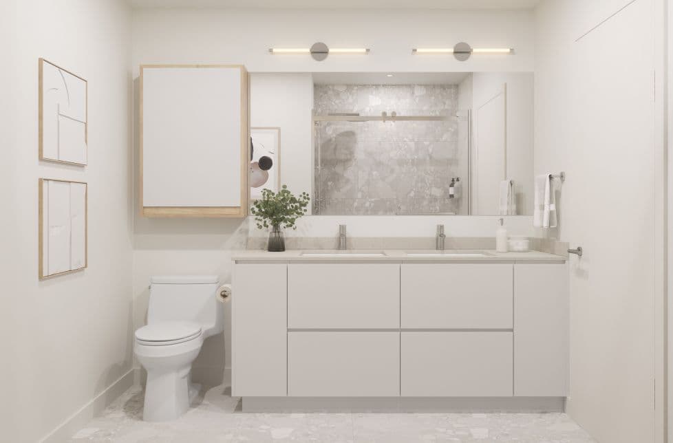 Marlow – A bathroom with a glass-enclosed shower, double-sink vanity, toilet, and marble tile flooring and walls.