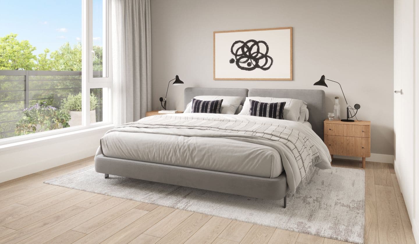 Marlow – A bedroom with a grey upholstered bed, patterned throw, nightstands with lamps, and a balcony with sliding glass doors.