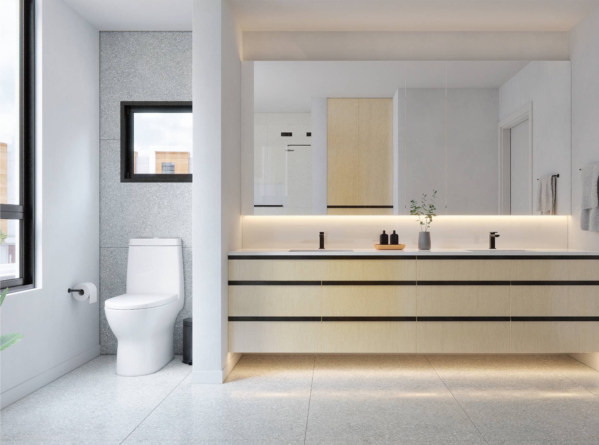 The Grove – A bathroom with a floating double-sink vanity in light wood, a large backlit mirror, and a separate toilet area with terrazzo-tiled walls and a small window.