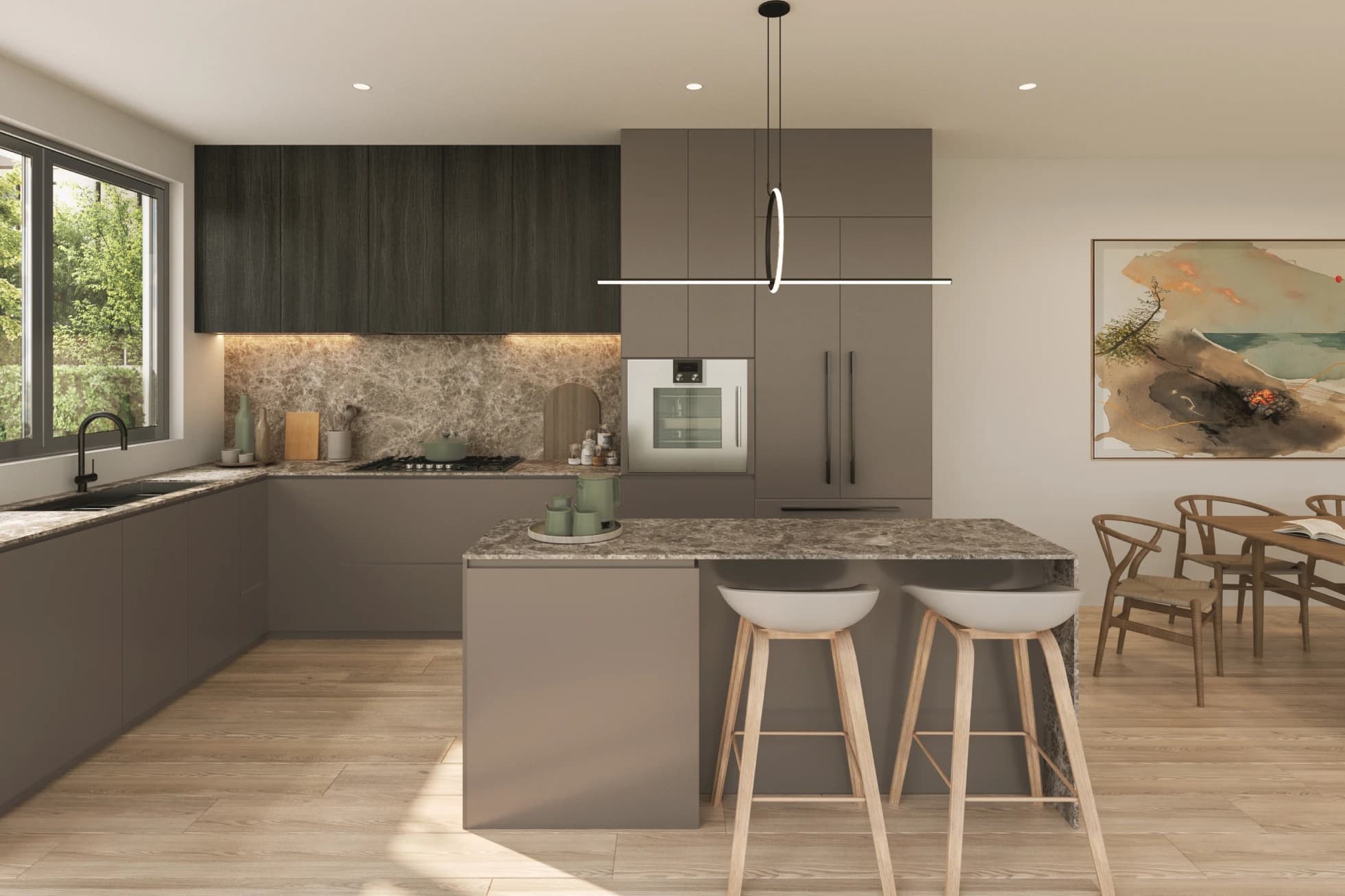 Emera – A modern minimalist kitchen featuring dark taupe and wood-grained cabinetry, beige marble countertops and backsplash, and a central island with two wooden bar stools. Sunlight streams across light hardwood floors, illuminating an adjacent dining area with a wooden table and a large abstract art piece on the wall.
