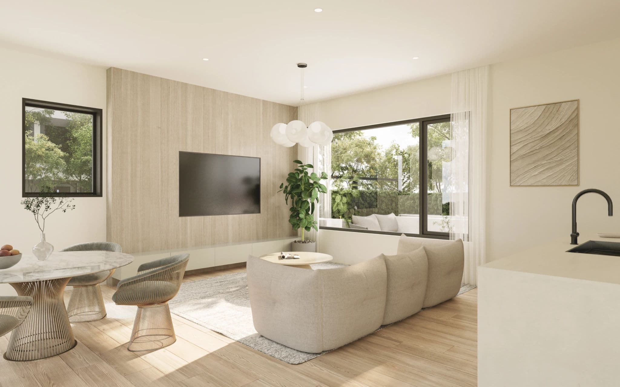 Emera – A modern open-concept living area features light wood flooring, a beige sectional sofa, and a wood-slat feature wall with a wall-mounted TV. Large black-framed windows bring in ample natural light and offer views of lush green trees outside.