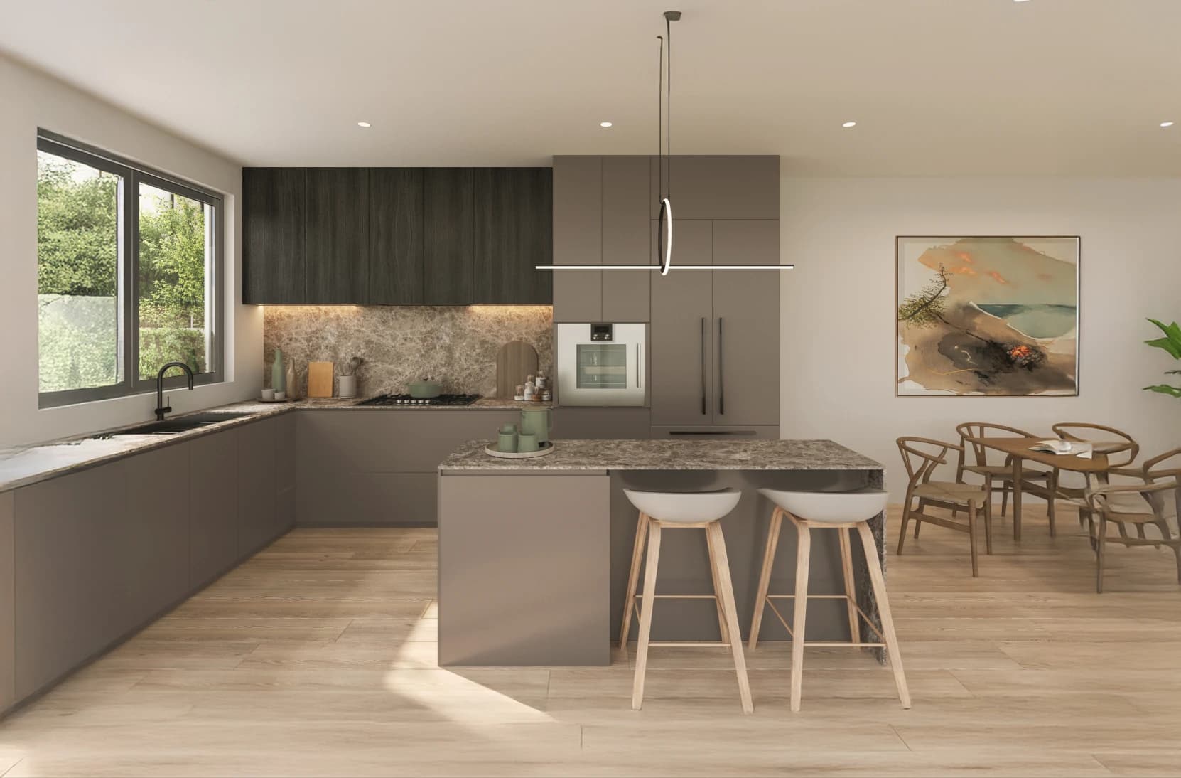 Emera – A modern open-concept kitchen features dark taupe cabinetry, brown marble countertops and backsplash, a central island with two barstools, and light wood flooring. A window looks out onto lush green foliage, while an adjacent dining area with a wooden table set and framed art sits illuminated by soft ambient lighting.