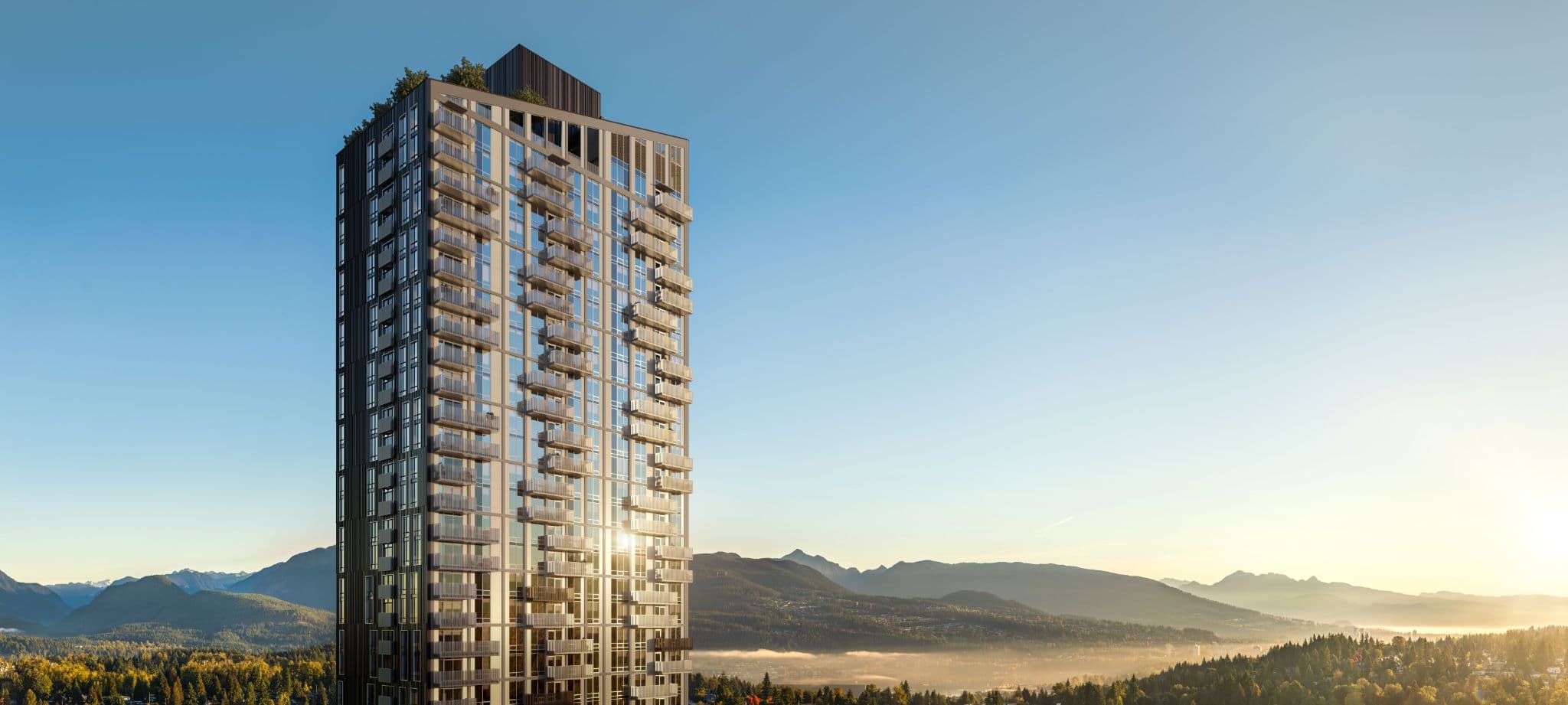 Olo Homes – Elevated view of the tower at sunrise with mountain ranges and a valley stretching into the distance.