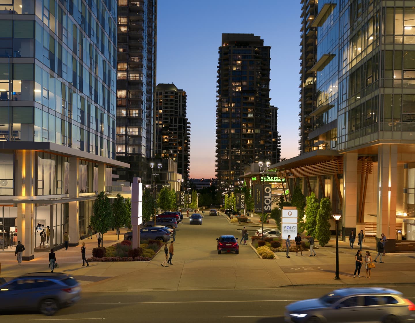 Solo District - Aerius – Twilight street-level view of the SOLO District plaza between high-rise towers, with a Whole Foods sign, retail storefronts, pedestrians, and cars on the road.