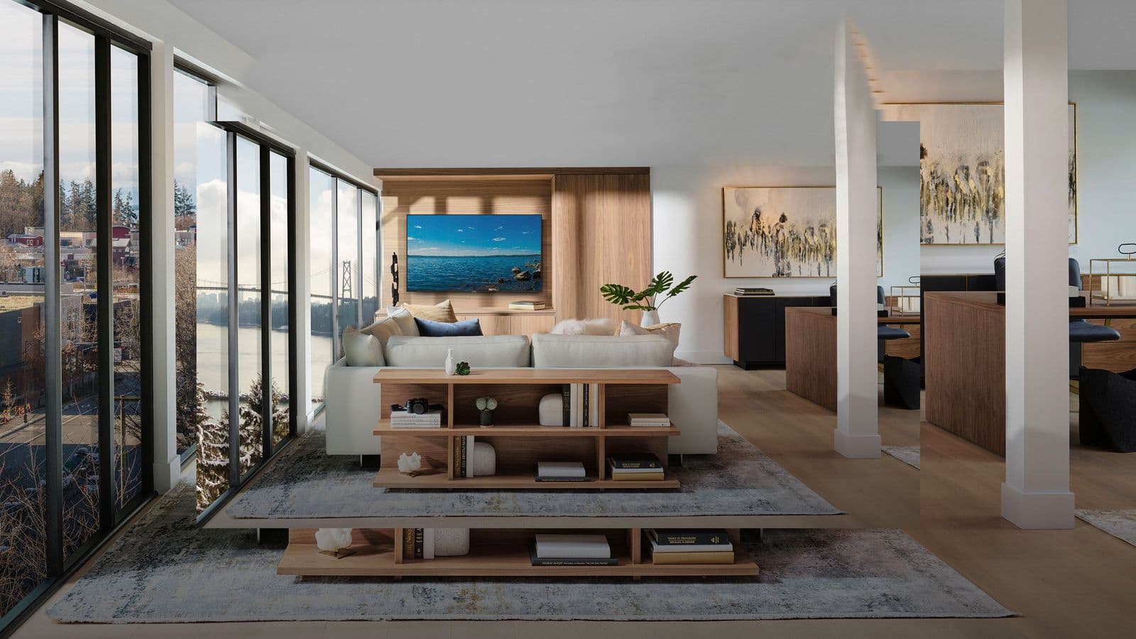 Executive on the Park – Open-concept living room with a white sectional sofa, wood shelving unit, columns, and a wall-mounted TV displaying a bridge and water scene.