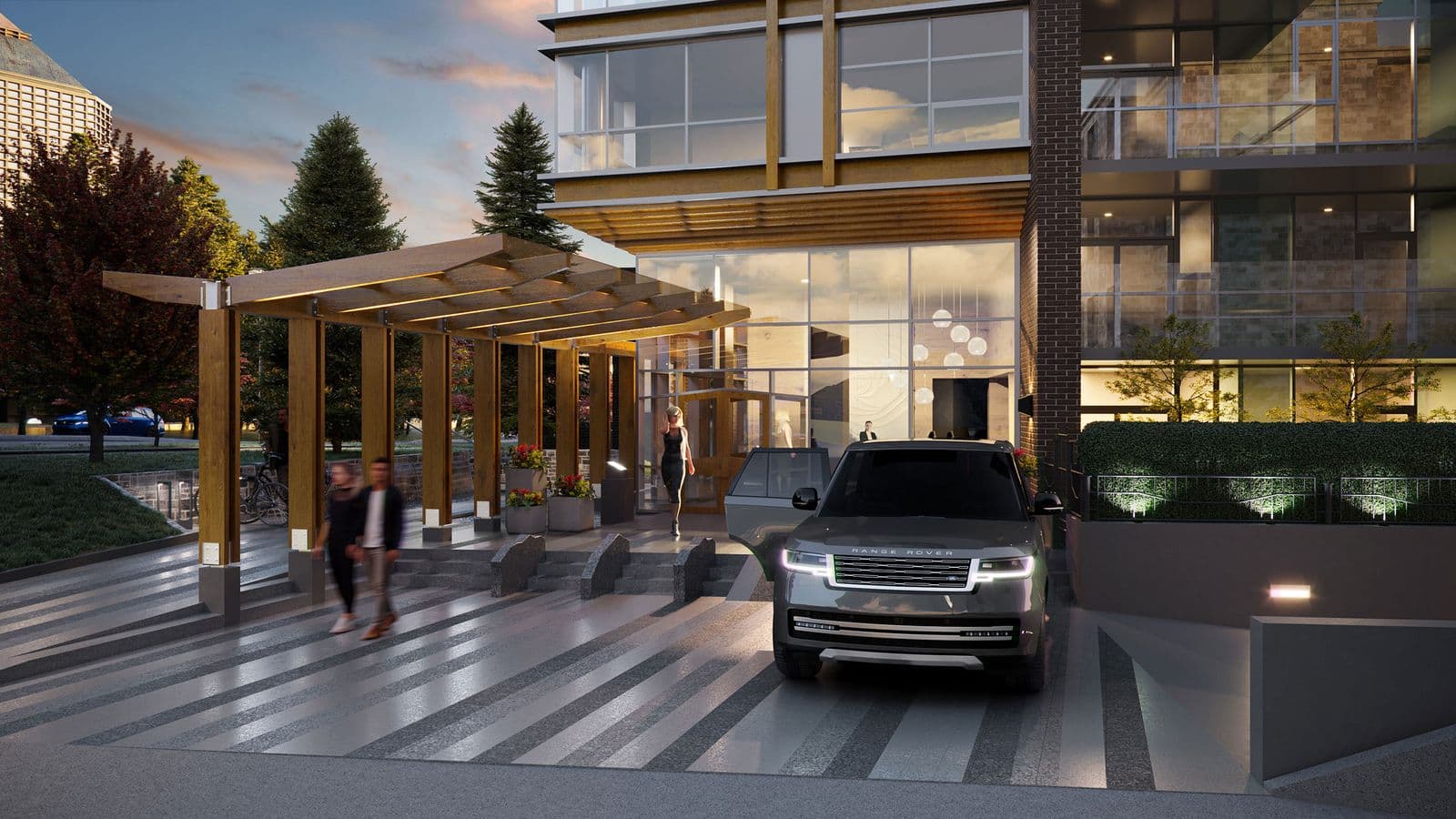 Executive on the Park – Dusk view of the building's entrance with a wood pergola porte-cochere, landscaped planters, and a car dropping off passengers.
