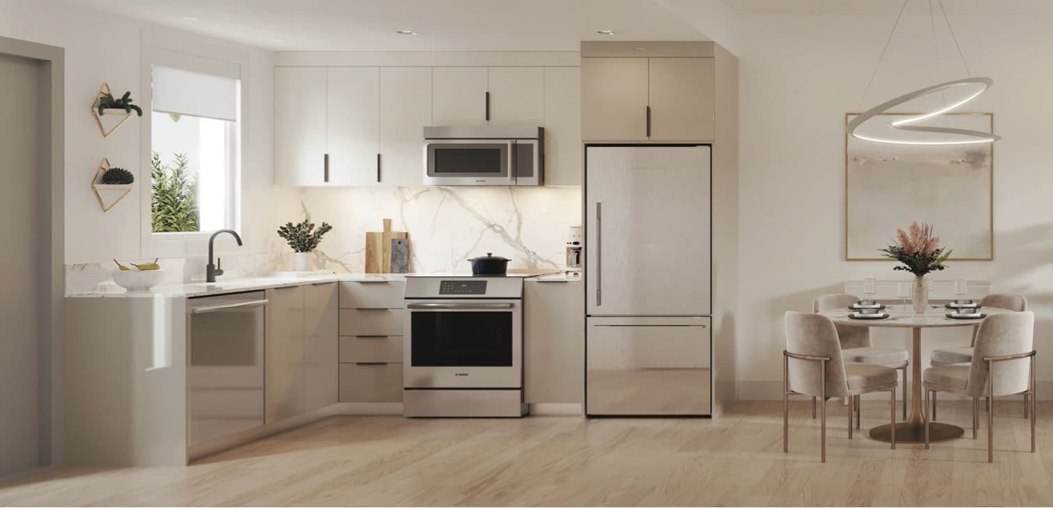 Lakewood – A kitchen with taupe cabinets, stainless appliances, marble backsplash, and an adjoining round dining table with upholstered chairs.