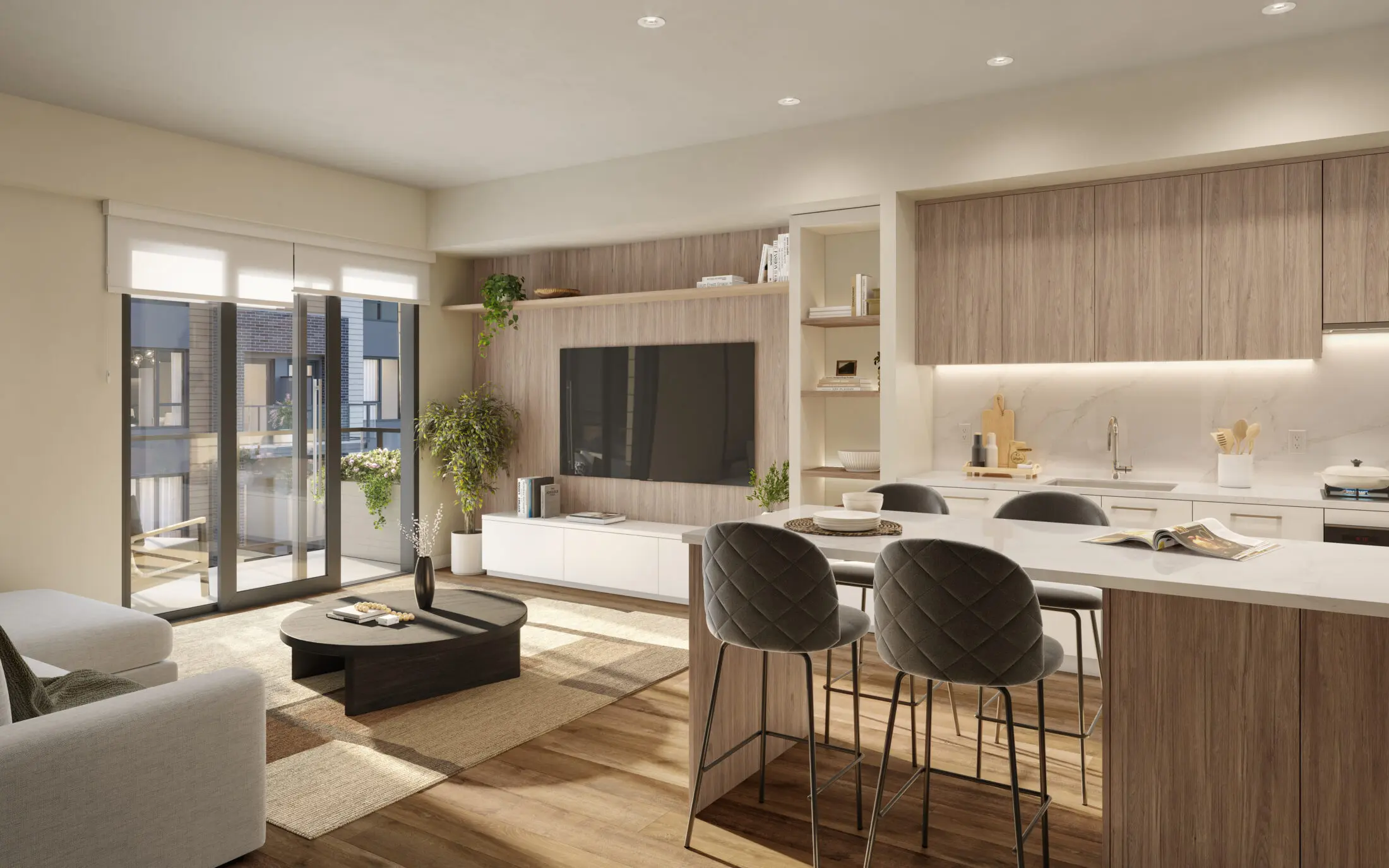 Lodana – An open-concept living room and kitchen with a wall-mounted TV, wood-panel media wall, dark coffee table, and a white kitchen island with bar stools.