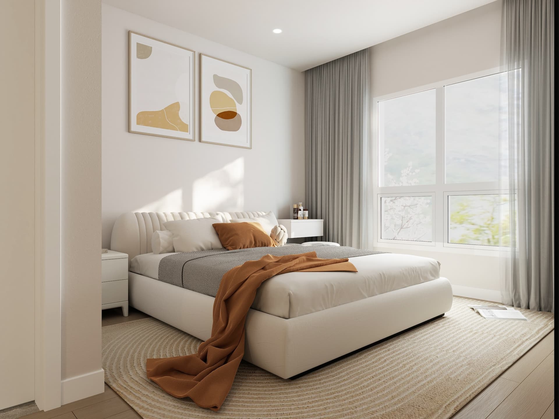 Kamilia – A modern bedroom illuminated by natural light from a large window framed with sheer and solid grey drapery. The room features a low-profile upholstered white bed with neutral and terracotta-toned bedding, a textured area rug, and minimalist abstract artwork hanging on the light wall.