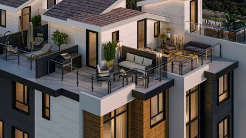 Burqville – An overhead view of private rooftop decks atop townhomes, furnished with outdoor sofas, a BBQ grill, planters, and lounge chairs at dusk.