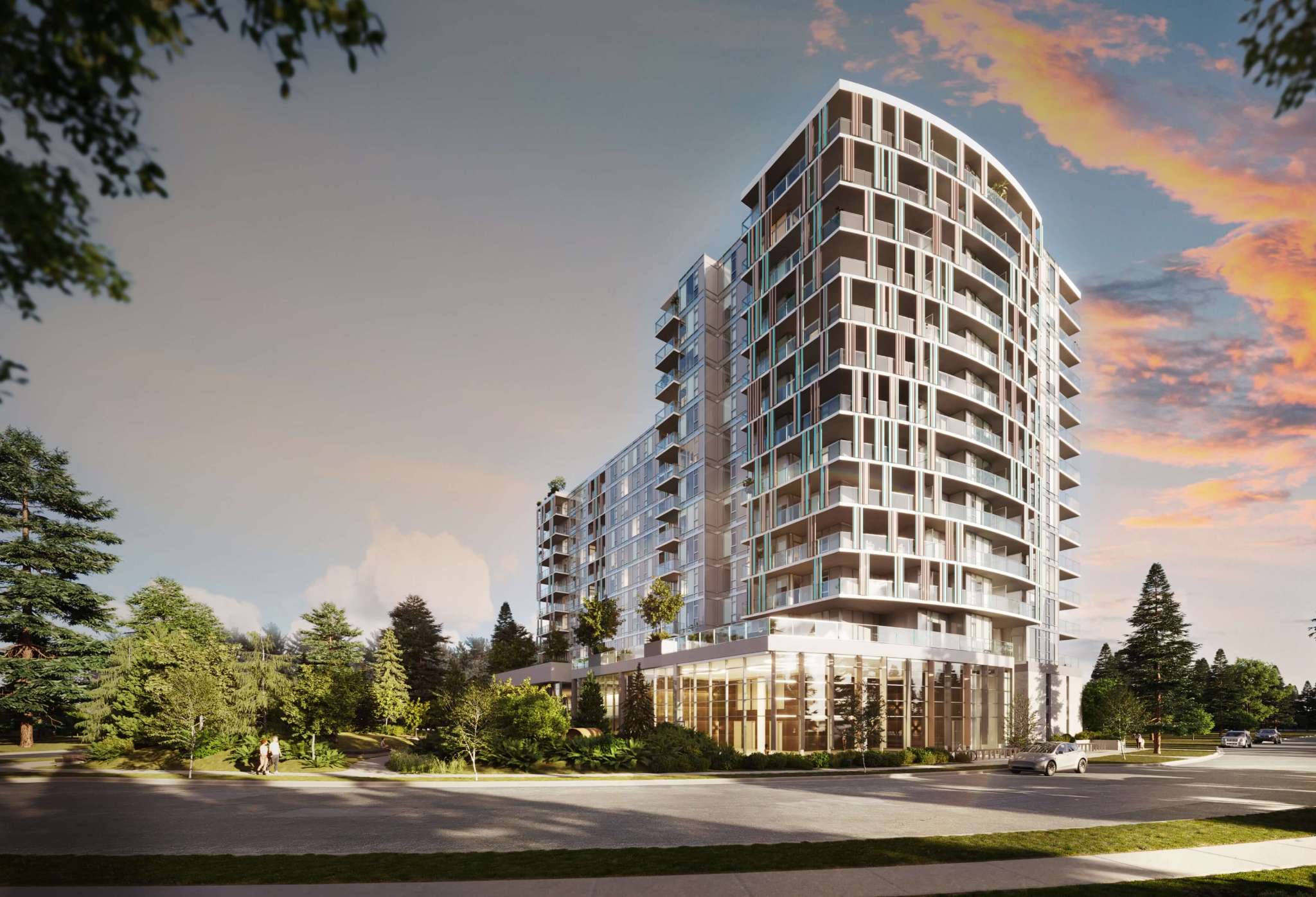 Talistar – A modern mid-rise residential tower with curved glass balconies and colorful vertical fins along the facade sits beside a quiet street surrounded by lush trees and manicured park greenery. The scene is illuminated by a warm sunset with pink and orange clouds glowing in the dusk sky.