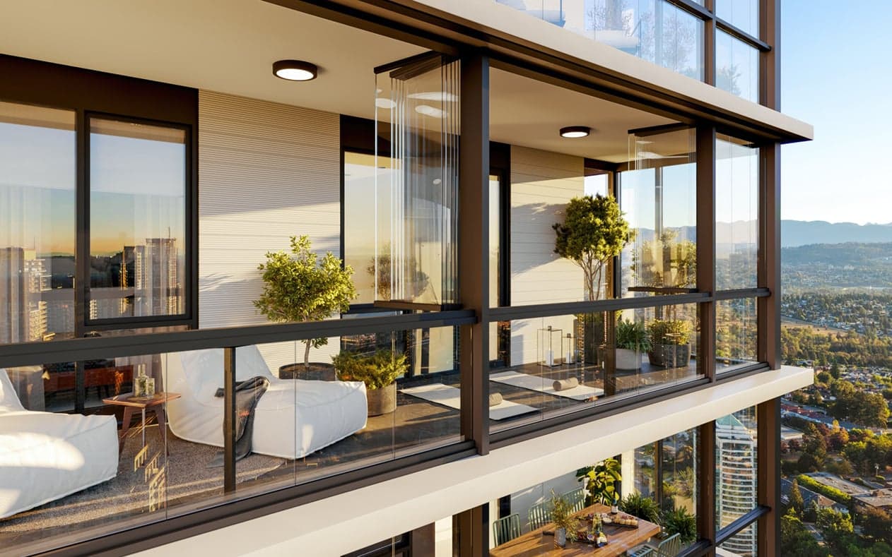Solhouse 6035 – A high-rise residential balcony equipped with retractable glass panels features lounge seating, yoga mats, potted plants, and dark metal railings. Warm late-afternoon sunlight illuminates the space, offering an expansive view of distant mountains and a sprawling city below.