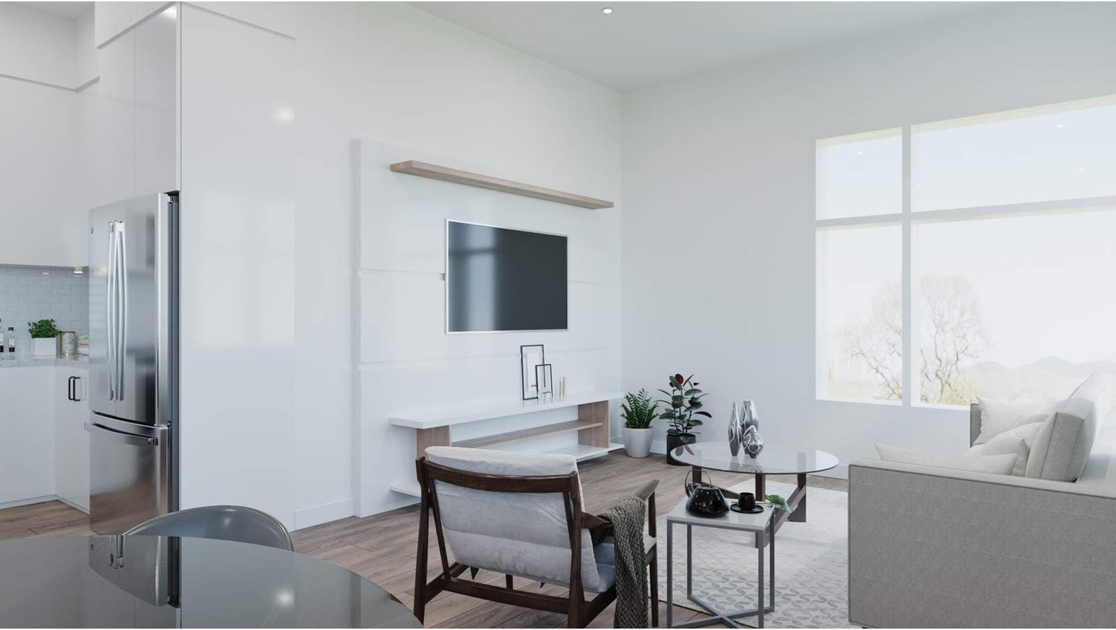 Douglas Green Living Condos – Living room with a wall-mounted TV, armchair, coffee table, and large windows showing trees and hills outside.