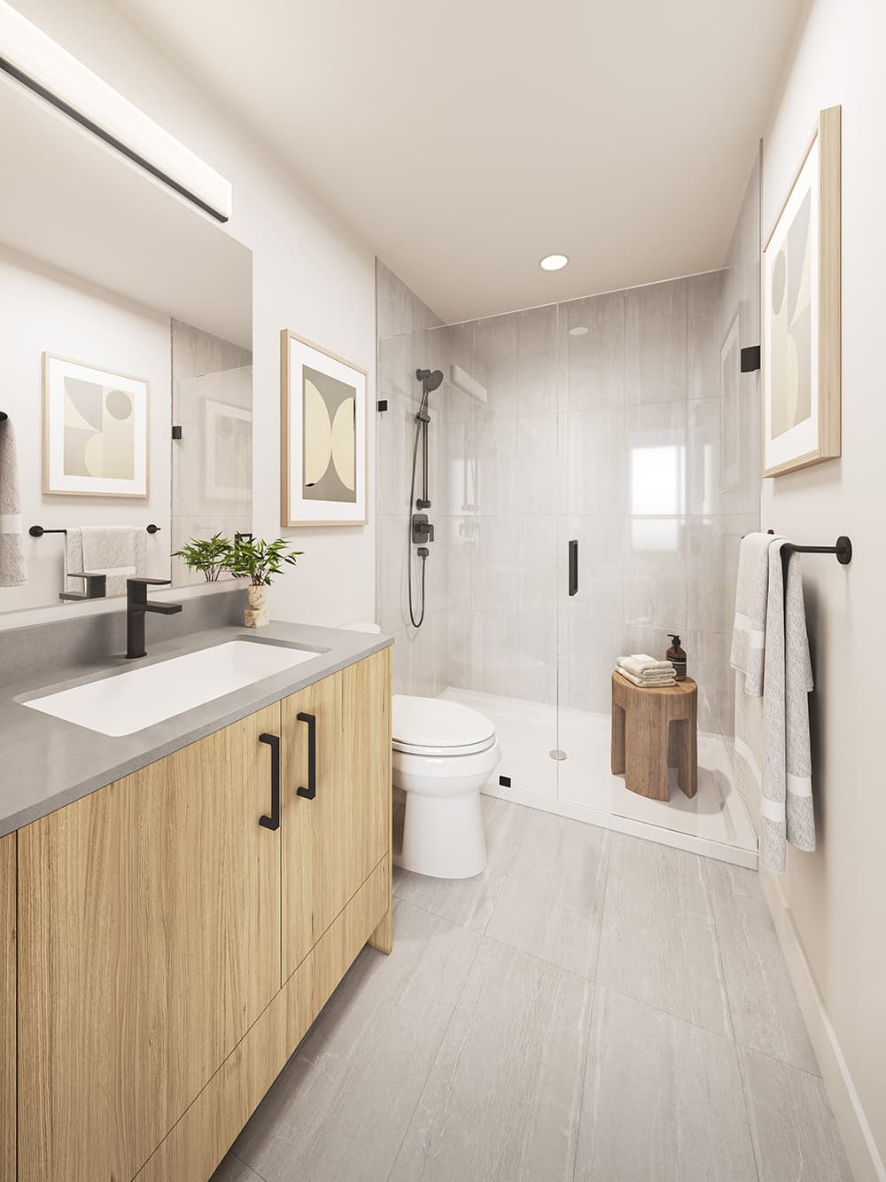 City Corners II – Bathroom with a wood vanity, glass-enclosed walk-in shower, and toilet.