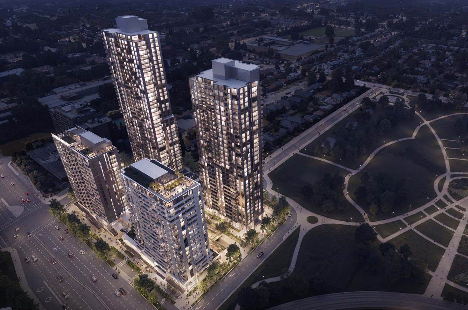 Mackin Parkside – A night aerial view of multiple lit high-rise towers within the development, set among city streets, a park, and surrounding neighbourhood.